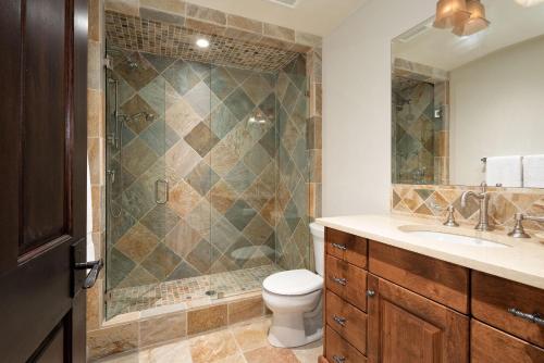 a bathroom with a shower and a toilet and a sink at 8166A SUITE Nicklaus North in Whistler