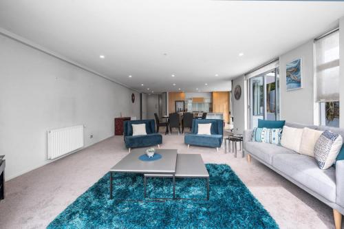 a living room with a couch and a table at Lakeside Apartment Waimahana 1 in Taupo