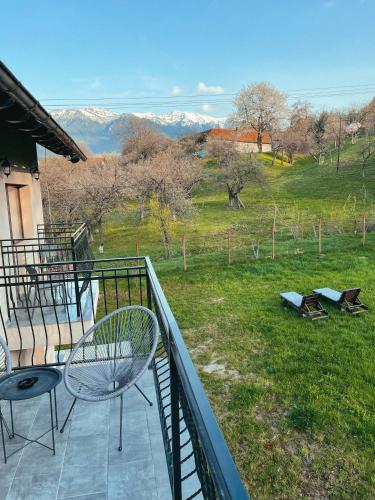 a balcony with two chairs and a view of a field at Transylvania Mountain View CDI in Bran