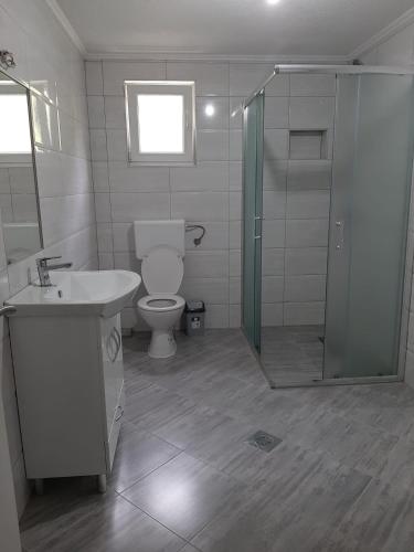 a bathroom with a toilet and a sink and a shower at Apartman Dujmović in Visoko