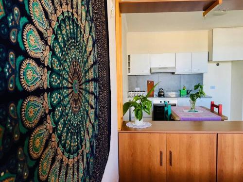 a kitchen with a large tapestry on the wall at Balcones del boulevard in Mariano J. Haedo