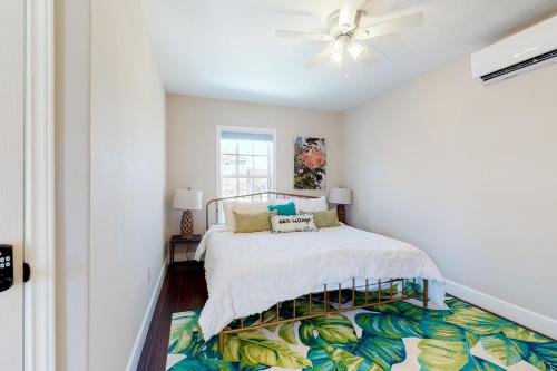 a bedroom with a bed and a ceiling fan at Market Gem in Galveston