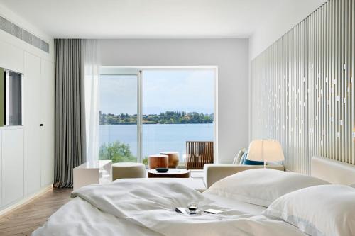 A bed or beds in a room at Nikki Beach Resort & Spa Porto Heli