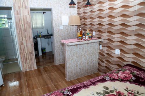 a bathroom with a bar in the middle of a room at Recanto das Videiras in Maria da Fé