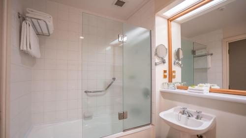 a bathroom with a shower and a sink at Scenic Hotel Southern Cross in Dunedin