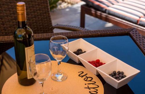 a table with two glasses and a bottle of wine and grapes at Apartment in Malinska Insel Krk 13004 in Malinska