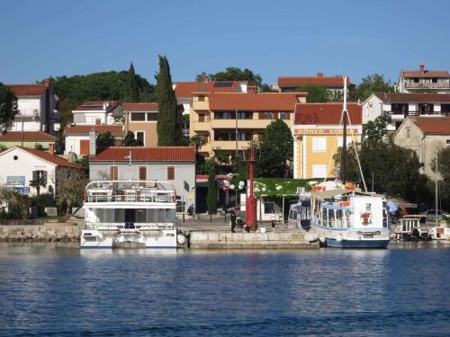 two boats docked in the water near a city at Apartment in Malinska Insel Krk 13004 in Malinska