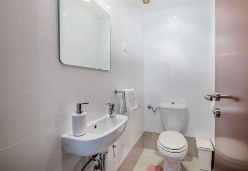 a white bathroom with a toilet and a sink at Apartment in Malinska Insel Krk 13004 in Malinska