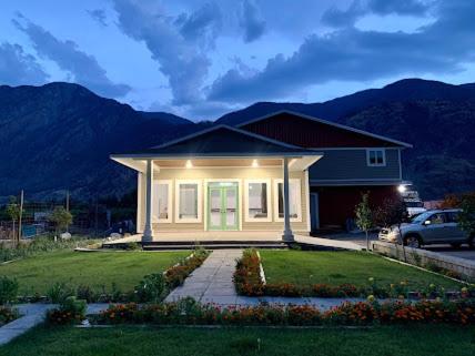 a small house with a car parked in front of it at Orchard View Motel in Keremeos