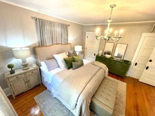 a bedroom with a bed with blue and green pillows at Vida Boutique Inn in Worcester