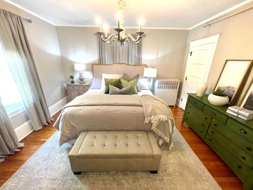 a bedroom with a large bed and a chandelier at Vida Boutique Inn in Worcester