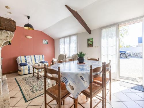 a dining room with a table and chairs at Beautiful holiday home with garden in Tamerville