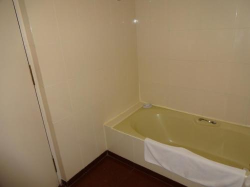 a bathroom with a bath tub with a towel on it at Radha Regent, Chennai in Chennai