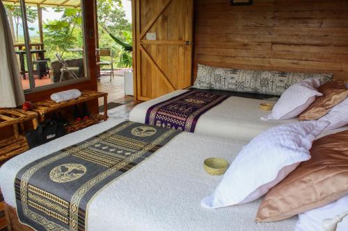 a bedroom with two beds in a room at Cacao Glamping in Cotundo