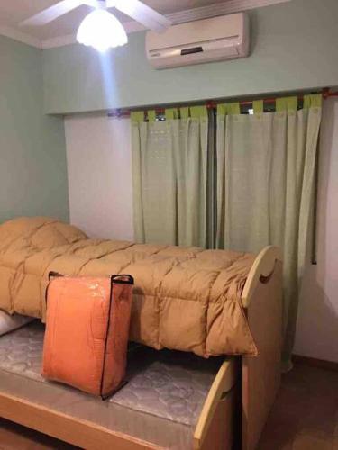 a bed sitting in a room with a window at Gran Casa Súper Equipada in Roldán