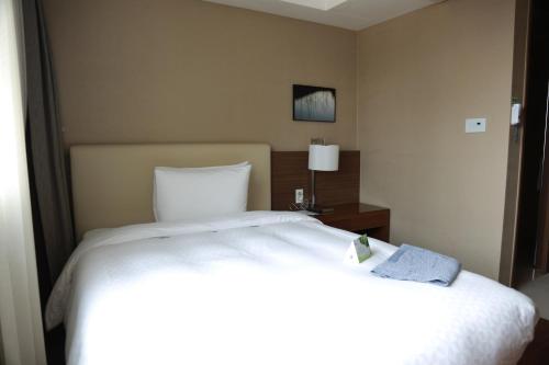 Katil atau katil-katil dalam bilik di Busan Business Hotel