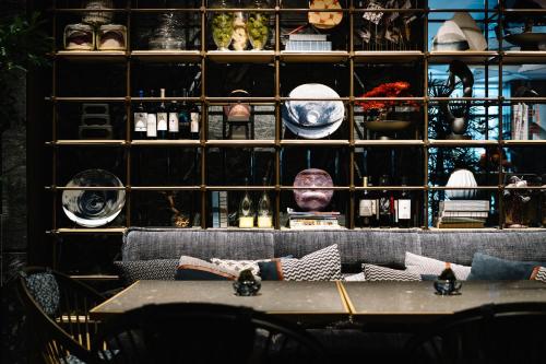 a room with a table and a wall filled with items at Mercure Kyoto Station in Kyoto