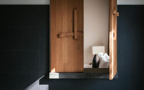 a wooden cabinet in a bathroom with a lamp at The One Nanyuan in Xinpu