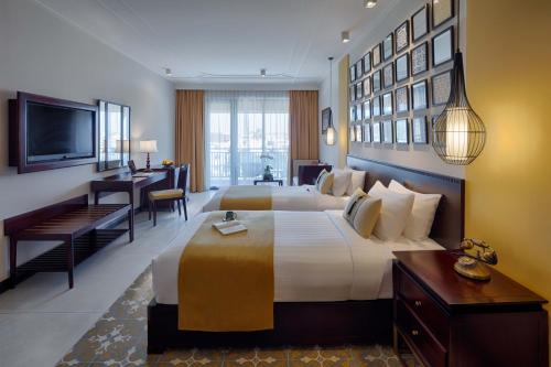 Voodi või voodid majutusasutuse Allegro Hoi An . A Little Luxury Hotel & Spa toas