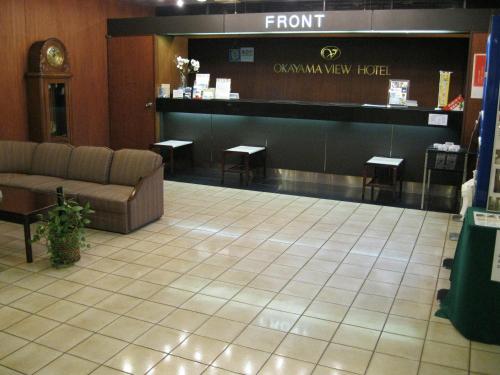 a waiting room with a couch in a store at Okayama View Hotel in Okayama