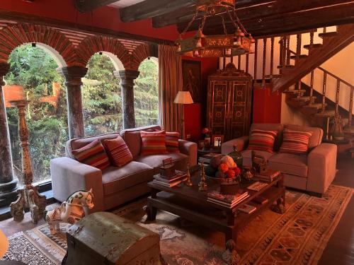 a living room with two couches and a table at Inka Tambo Hacienda in Cusco