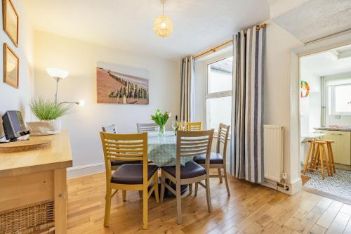 a kitchen and dining room with a table and chairs at Sea Spray in Watchet