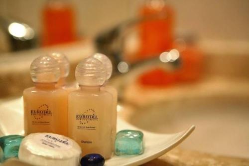 two bottles of soap sitting on top of a sink at Hotel Eurotel El Bosque in Santiago