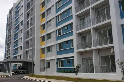 an apartment building with blue and yellow at Ike village in Kota Samarahan