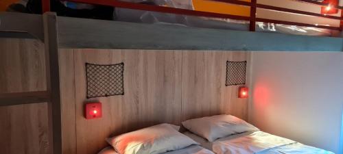 a bedroom with a bunk bed with two red lights at hotelF1 Fréjus Roquebrune sur Argens in Roquebrune-sur-Argens