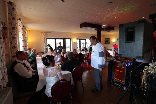 a man standing in a room with a group of people at Goldene Krone in Belgershain