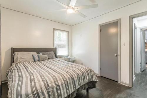 a bedroom with a bed and a ceiling fan at The Sweet Creek Luxurious Villas in Atlanta