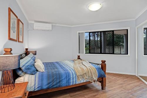a bedroom with a bed and a window at Unit 2 of 6 Indigo Avenue Rainbow Beach in Rainbow Beach