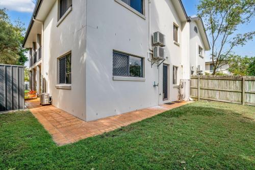 a white house with a fence and a yard at Unit 2 of 6 Indigo Avenue Rainbow Beach in Rainbow Beach