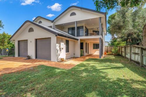 a white house with a fence and a yard at Unit 2 of 6 Indigo Avenue Rainbow Beach in Rainbow Beach