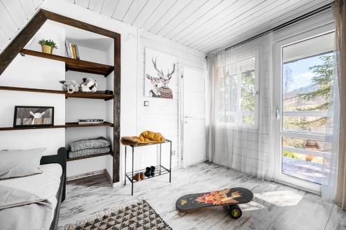 a bedroom with a bed and a skateboard on the floor at Aspen - Domek w Korbielowie in Korbielów