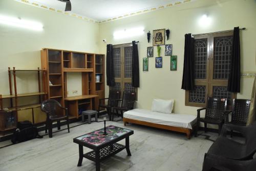 a living room with a bed and chairs and a table at jayaram Home in Chittoor