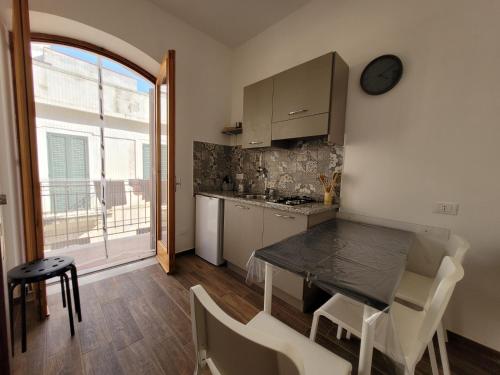 a kitchen with a table and a dining room at Casa "Paolo e Francesca" Monolocali in Scilla