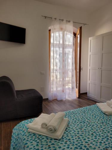 a room with a bed and a couch and a window at Casa "Paolo e Francesca" Monolocali in Scilla
