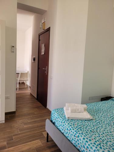 a bedroom with a bed and a hallway with a door at Casa "Paolo e Francesca" Monolocali in Scilla