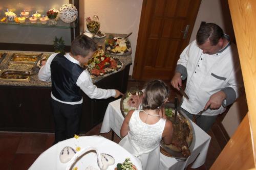 a group of people standing around a table with food at Goldene Krone in Belgershain