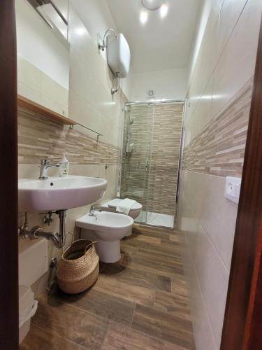 a bathroom with a sink and a toilet and a shower at Casa "Paolo e Francesca" Monolocali in Scilla