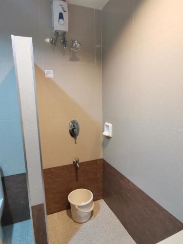 a small bathroom with a toilet in a stall at Bayview Country Inn El Nido in El Nido