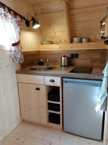 a small kitchen with a sink and a stove at des Vignes et des Songes in Saint-André-et-Appelles