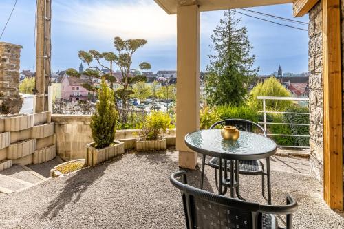 a patio with a table and chairs and a view at Le 31-GregIMMO-Appart'Hôtel in Montbéliard