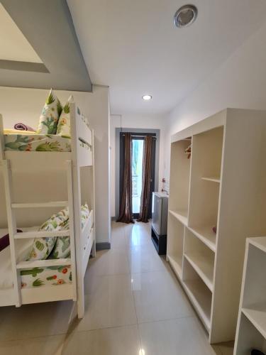 a room with two bunk beds and a hallway at Bayview Country Inn El Nido in El Nido