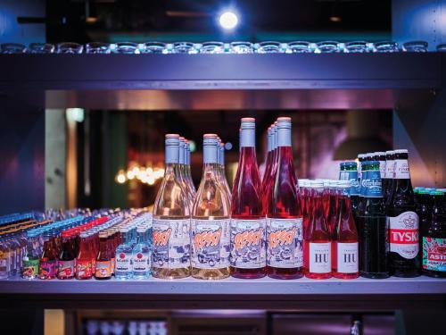a row of bottles of alcohol on a shelf at Urban Nature St Peter-Ording in Sankt Peter-Ording