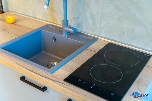 a kitchen sink with a faucet on a counter at MODERN apartments WAVE near the AIRPORT in Velika Gorica