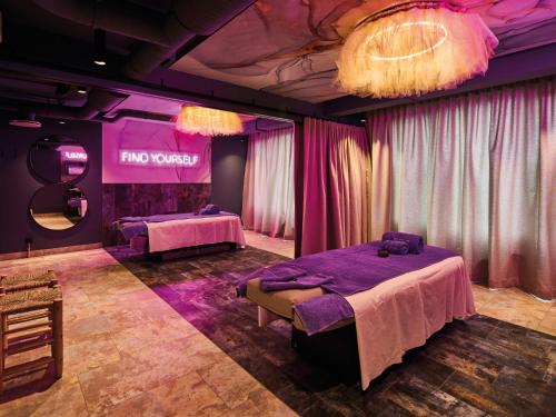 a purple room with two beds and a mirror at Urban Nature St Peter-Ording in Sankt Peter-Ording