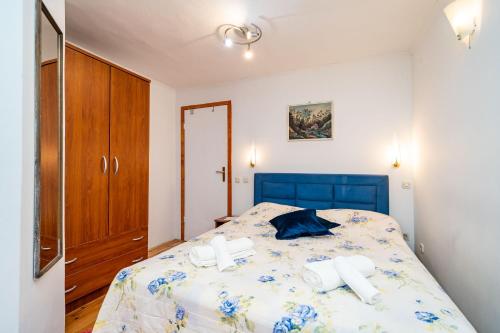 a bedroom with a bed with two towels on it at Rooms Fausta Old Town in Dubrovnik