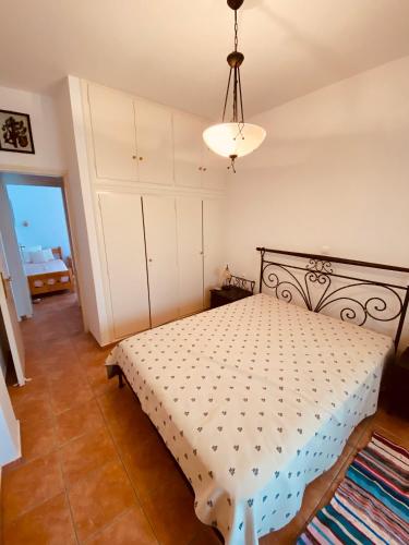 a bedroom with a bed and a chandelier at Loutra Hills in Loutra